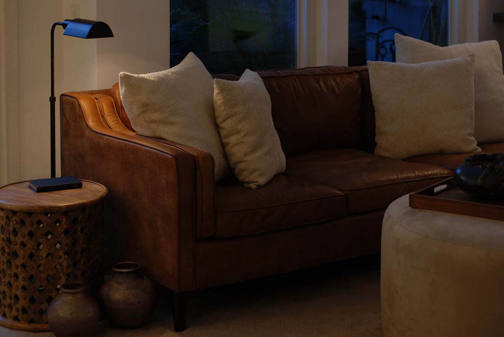 Leather couch with task lighting and copper pots.