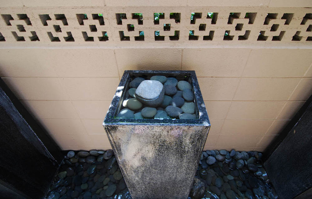 These fountains are about four feet tall and seven of them were placed around the patio to block traffic noise.