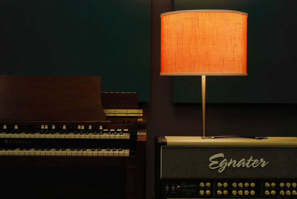 B3 Hammond Organ with amp, coral shaded floor lamp and dark green acoustic panels in a music studio at LACM.