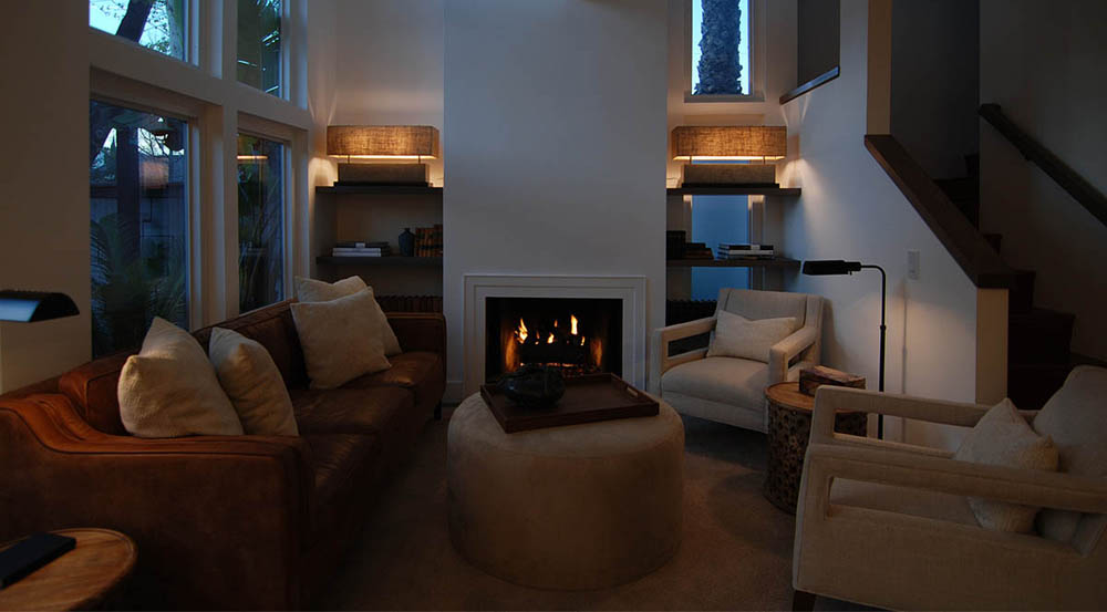 The living room at night. Custom shelves were put in on either side of the fireplace.