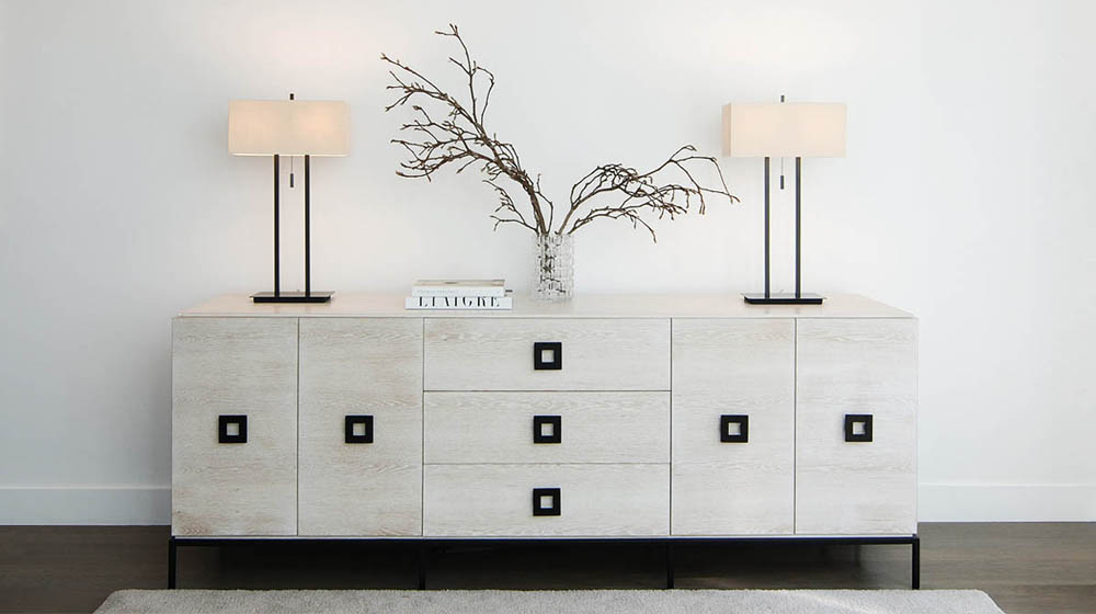 A custom limed white oak credenza with bronze handles and base.