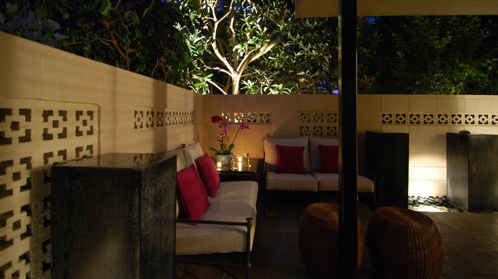 Condominium patio with water features and seating area.