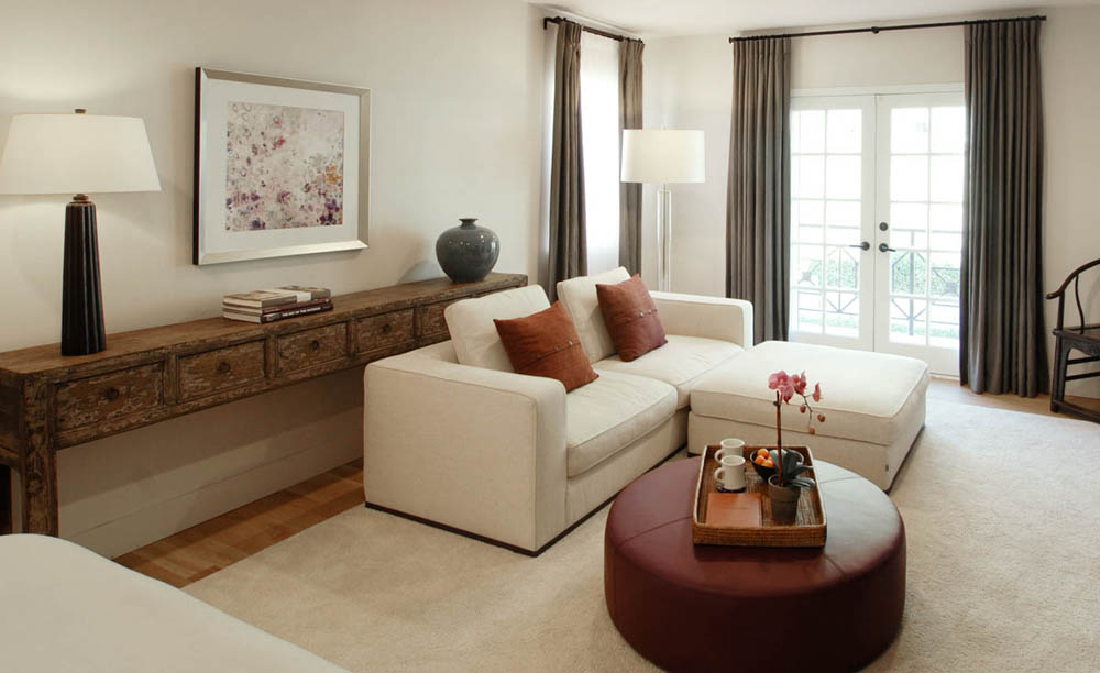 Master bedroom with purple leather ottoman and love seat for watching TV.